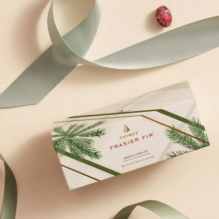 Thymes Frasier Fir aromatic candle set box with pine branch design, green ribbon, and red berry