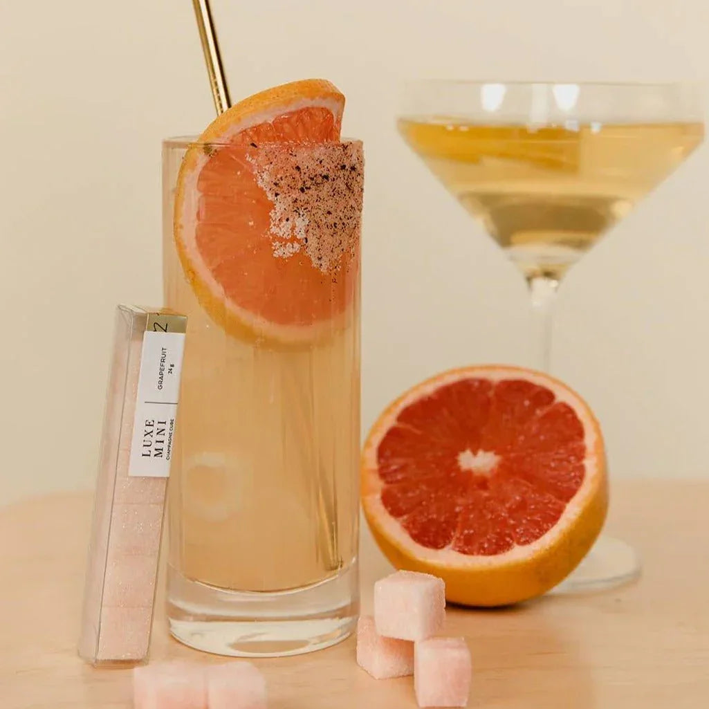 Grapefruit cocktail with sugar-rimmed glass, grapefruit slice, Luxe Mini sugar cubes, and martini glass