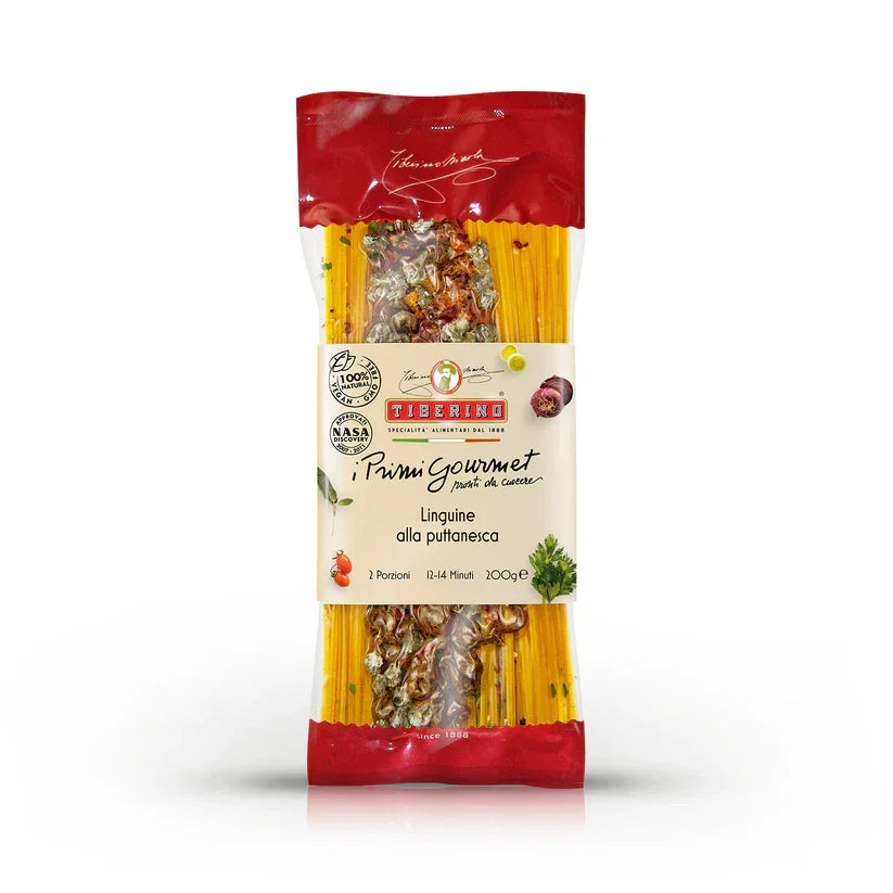 Package of Tiberino Primi Gourmet Linguine alla Puttanesca pasta with visible capers and red onion accents