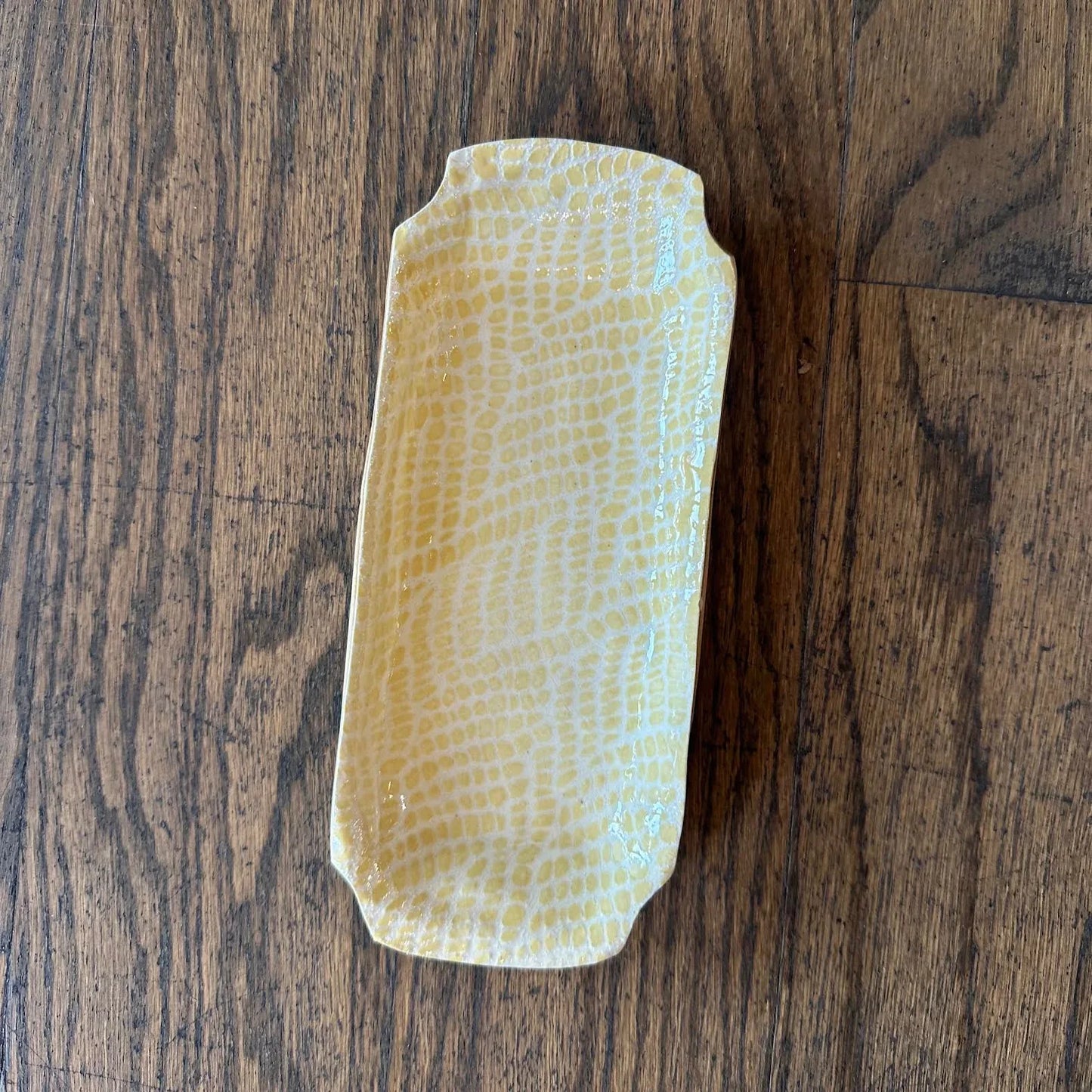 ceramic butter dish with light yellow glaze and textured pattern