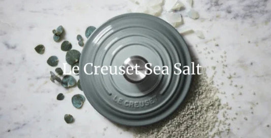 Le Creuset blue stoneware lid on marble surface with sea salt crystals scattered around