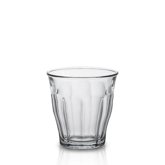 Clear empty faceted glass tumbler on white background