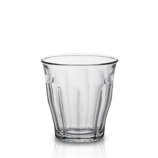 Clear vintage-style glass tumbler with fluted sides on white background