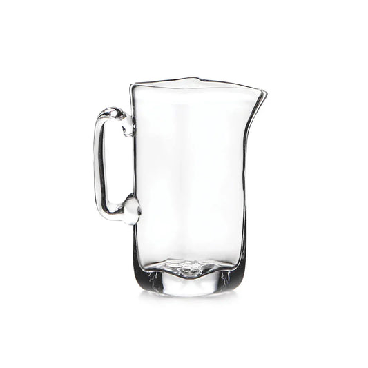 Clear glass pitcher with handle and spout on white background