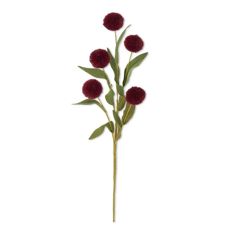 Artificial red pompom flower stem with green leaves on white background