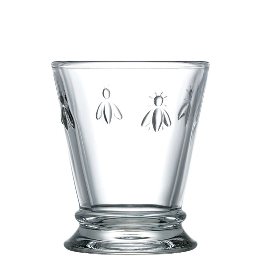 Clear glass tumbler with embossed bee designs around the upper part and a flared base