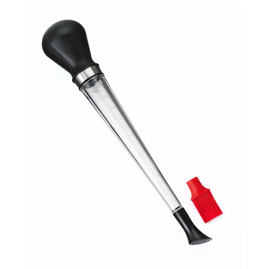 Black bulb baster with clear measurement tube and red silicone basting brush on white background