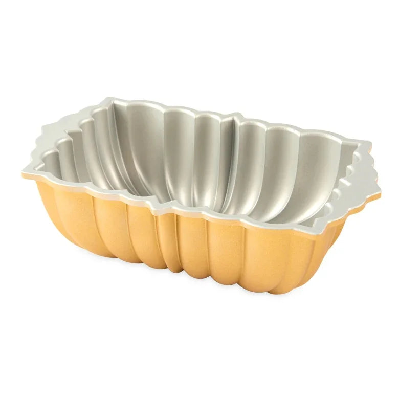 Classic fluted loaf pan with gold exterior and silver non-stick interior, ideal for baking
