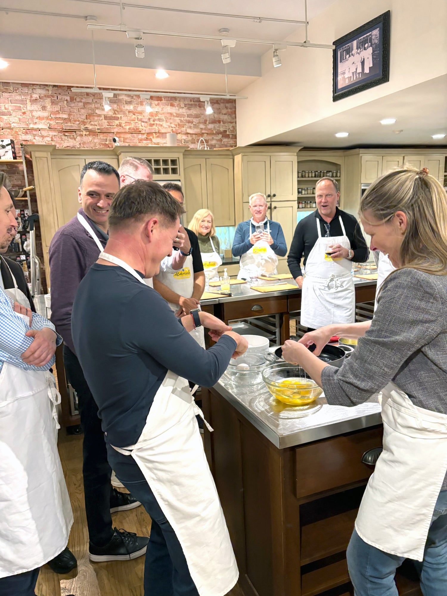 Guests participating in a hands-on corporate team building class at Marcel's Culinary Experience in Glen Ellyn, Illinois