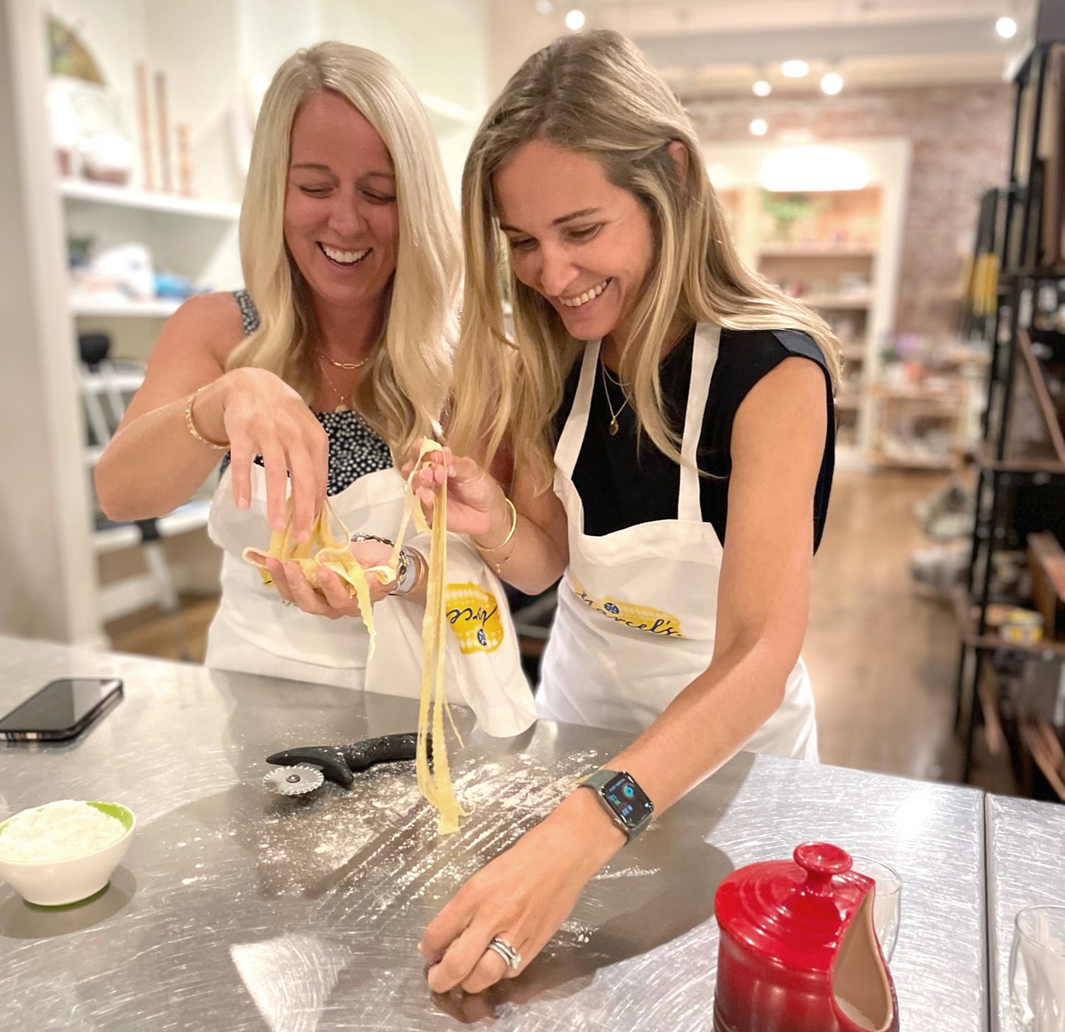 Chef-led hands-on corporate cooking class for groups at Marcel's Culinary Experience — guests preparing a multi-course meal together