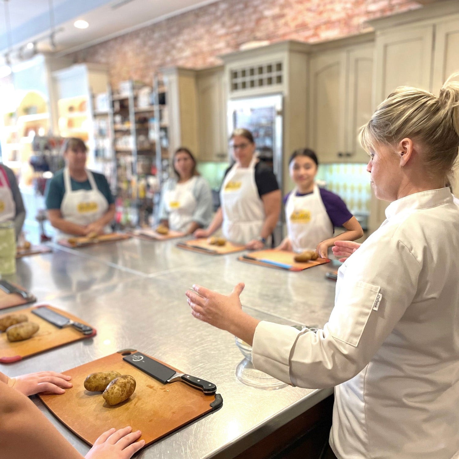 Group of people in Marcel's kitchen learning about food preparation
