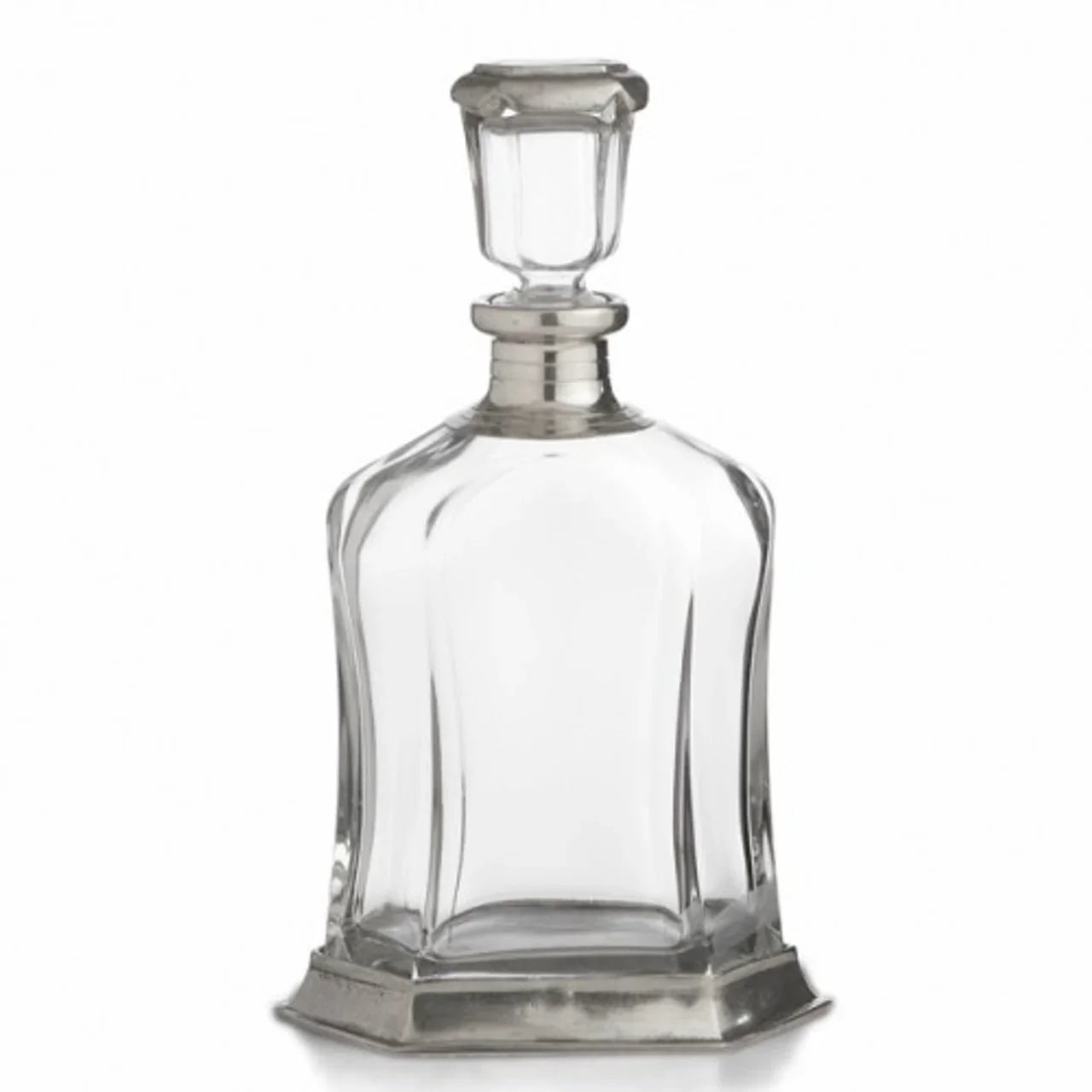 Clear glass decanter with silver metal base and stopper on white background