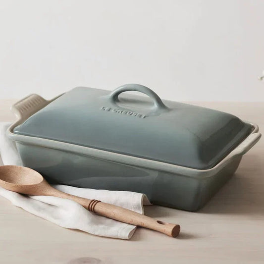 Le Creuset Heritage Rectangular Casserole in Sea Salt with lid and wooden spoon.