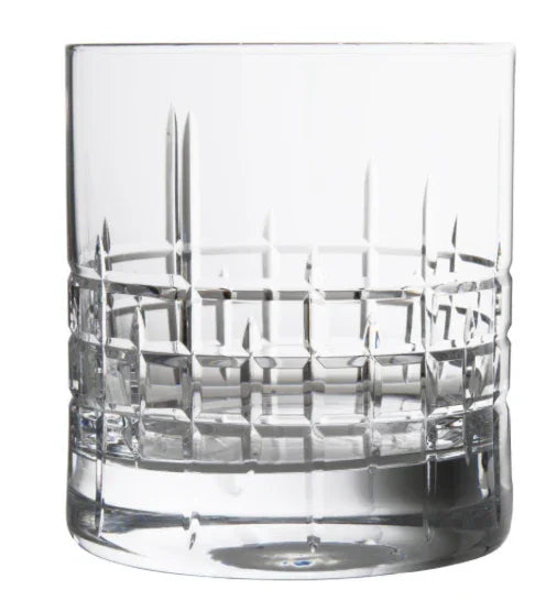 Clear crystal whiskey glass with geometric etched pattern on white background