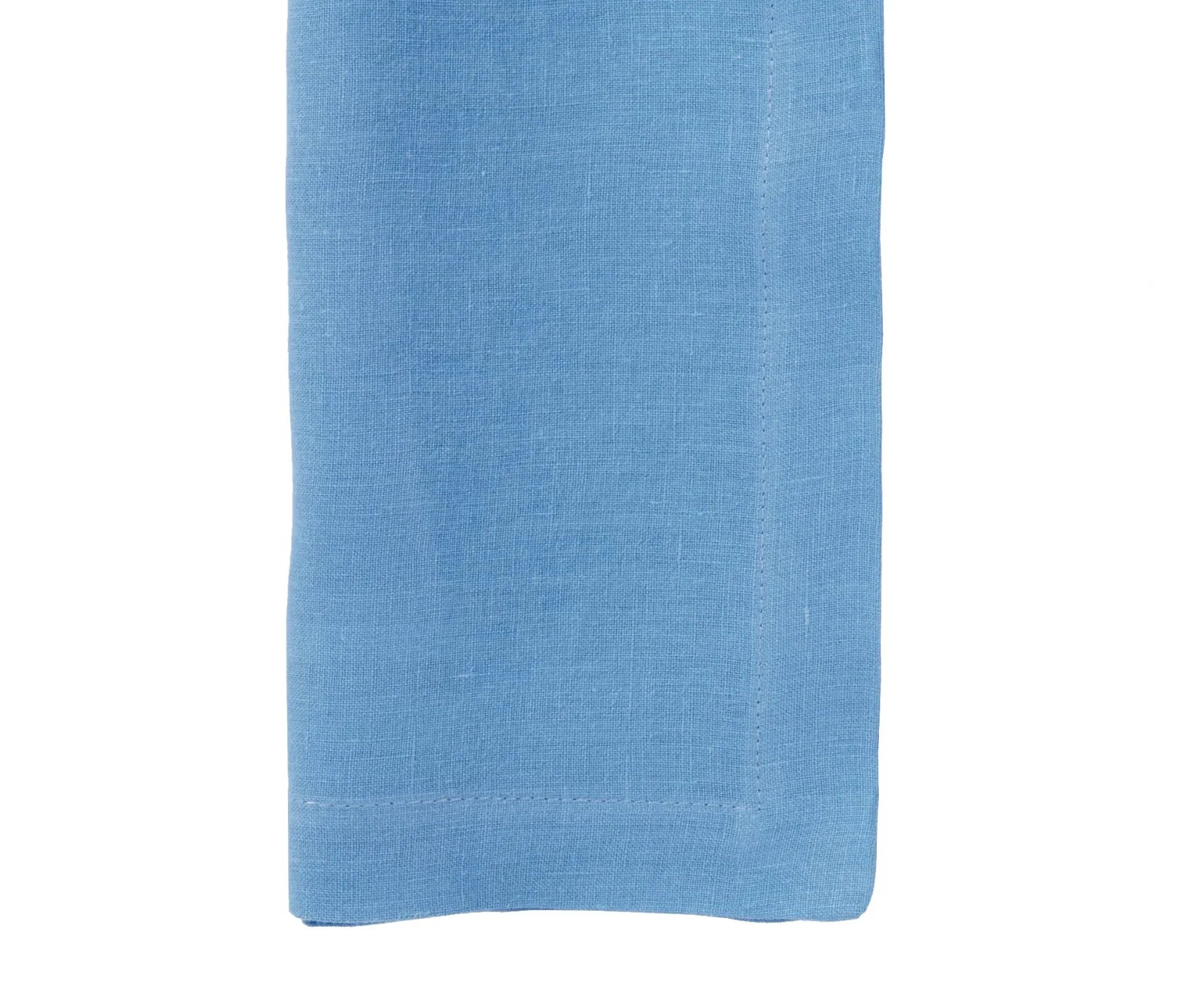 Blue linen napkin with visible stitching on white background
