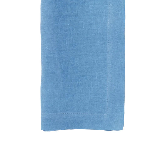 Blue linen napkin with visible stitching on white background