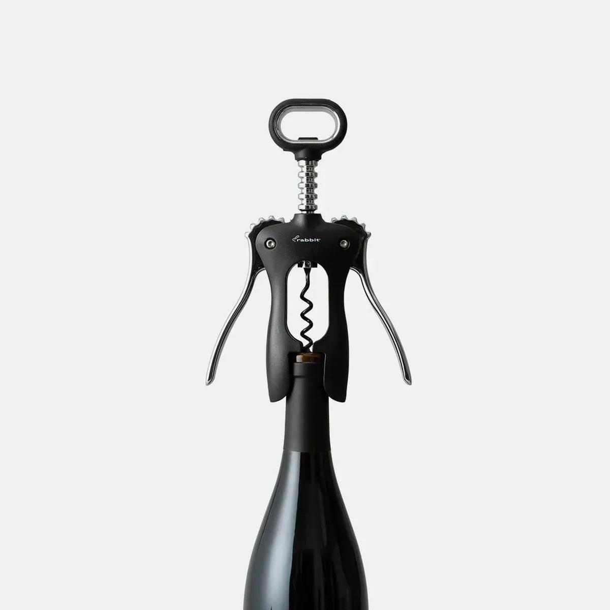 Black wing corkscrew opening a wine bottle on white background