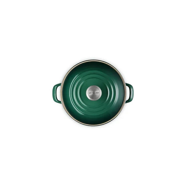 Top view of green Le Creuset cast iron Dutch oven lid with silver knob and handles