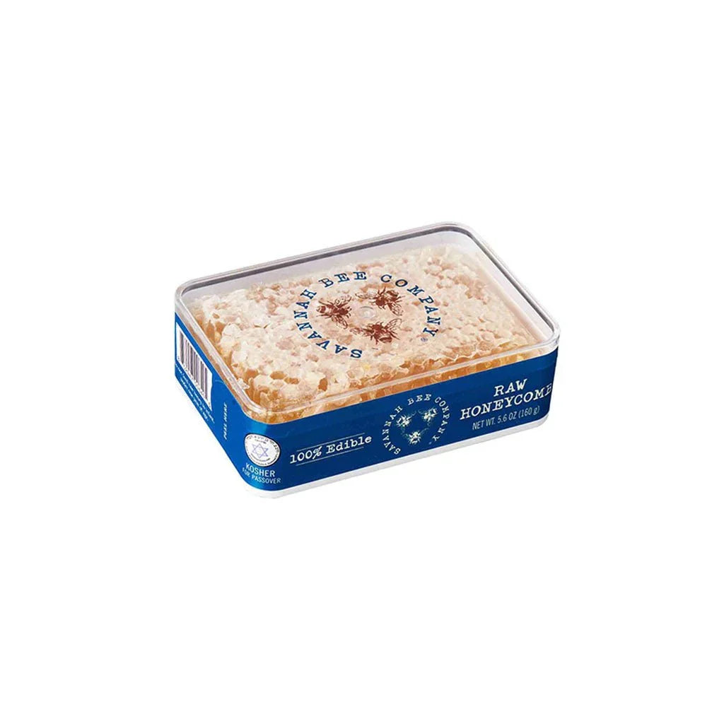 Raw honeycomb in clear plastic container with blue label from Savannah Bee Company