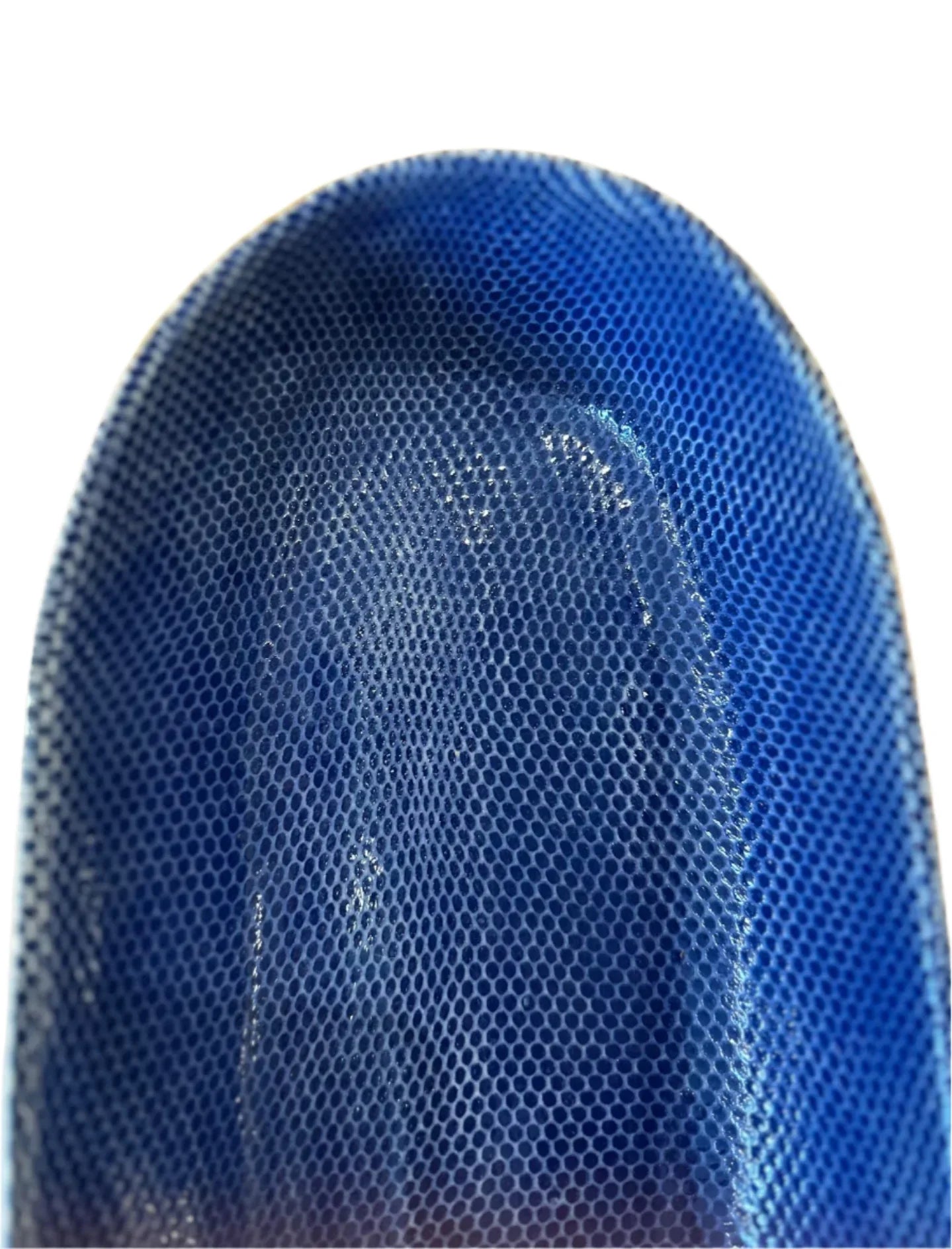 Close-up of blue textured carbon fiber material with honeycomb pattern