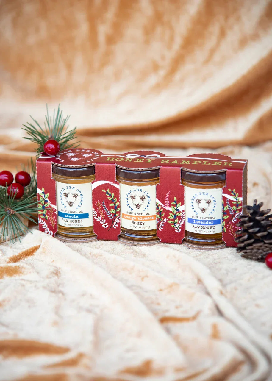 Savannah Bee Company honey sampler set with acacia, orange blossom, and lavender raw honey jars in festive packaging