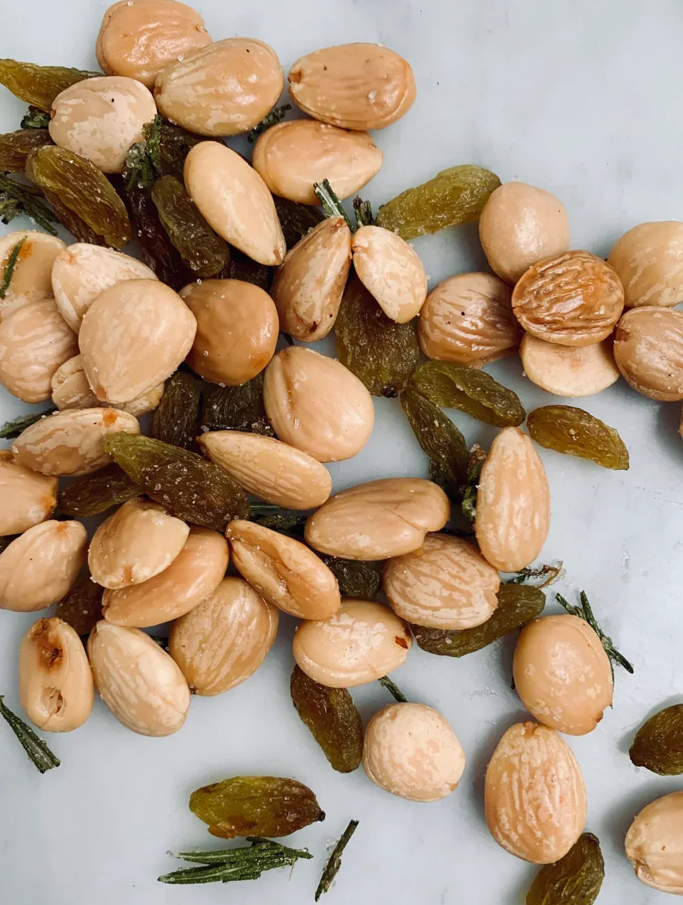 marcona almonds candies rosemary green raisins close up