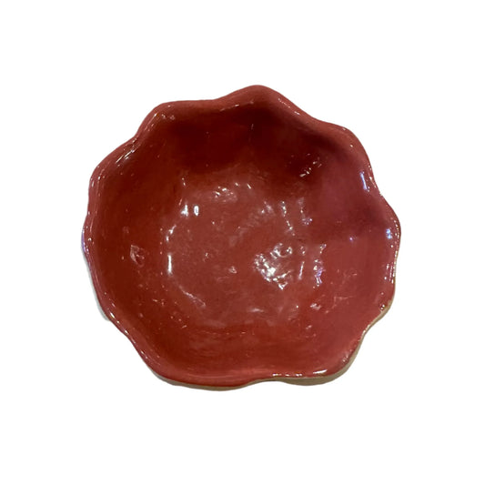 Red ceramic bowl with wavy edge